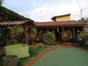 a house with a green couch in front of it at Casa Irazu in Cartago