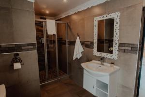 a bathroom with a sink and a shower at Le Grant Guesthhouse in Kroonstad