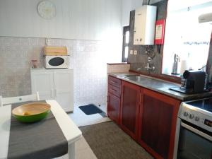 a kitchen with a bowl on top of a counter at my secret beach... in Vila Chã