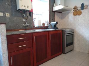 a kitchen with a sink and a stove at my secret beach... in Vila Chã +20 photos