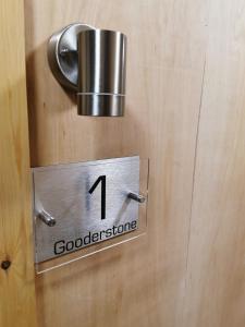 a sign on a wooden door with theigil of a doorkeeper at The Barn in Swaffham