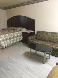 A bed or beds in a room at Regency Inn
