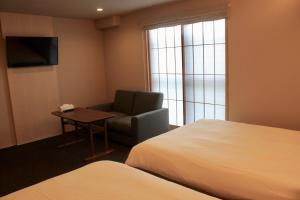 Rúm í herbergi á HIZ HOTEL Gion-Shirakawa