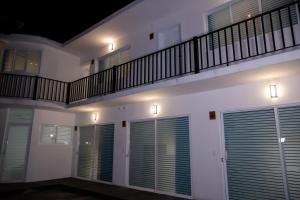 a white building with windows and a balcony at Casa Iztac in Zacatlán