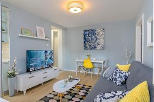 a living room with a couch and a tv at Charming Place near Centre with GARAGE parking in Zagreb
