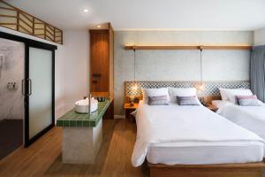 Tempat tidur dalam kamar di Himku Hotel - adult only