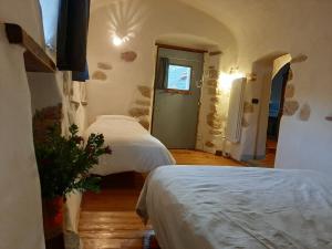 a bedroom with two beds in a room with a window at Guesthouse Contrada Bolla in Finale Ligure