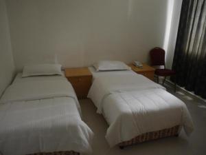 Letto o letti in una camera di Plaza Hotel