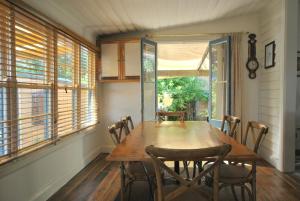 a dining room with a wooden table and chairs at Cooma Cottage in Cooma