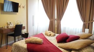 a bedroom with a bed with pillows and a desk at Room & Breakfast Canalino 21 in Modena