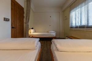 Postel nebo postele na pokoji v ubytování Cozy House Hostel