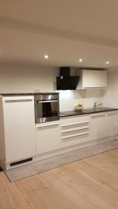 a kitchen with white cabinets and a counter top at Lilli Ferienwohnung in Handewitt
