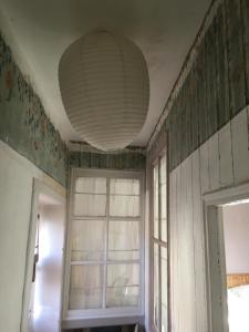 ein leeres Zimmer mit einem Fenster und einer Decke in der Unterkunft La Maison Haute in La Fosse-de-Tigné