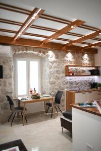 a kitchen and dining room with a table and chairs at Studio Apartment San Marino in Dubrovnik in Dubrovnik