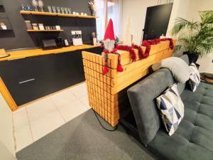 a santa claus sitting in a basket in a room at Apartman Park Žilina & Free Parking in Žilina