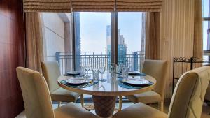 a dining room with a table and chairs and a large window at Lux BnB Standpoint Tower Burj&Sea Views in Dubai