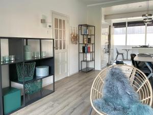 a living room with a chair and a table at Alibi aan Zee in Wijk aan Zee