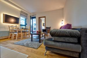 a living room with a couch and a table at Zlatibor apartman Asteri in Zlatibor