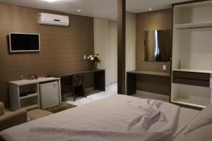 Ένα ή περισσότερα κρεβάτια σε δωμάτιο στο Pak Suítes Hotel