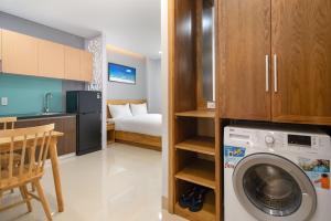 a kitchen and a living room with a washing machine at ST Motel & Apartment in Danang