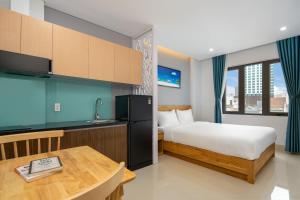 a hotel room with a bed and a table at ST Motel & Apartment in Danang