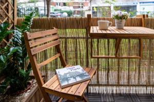 a book sitting on a wooden table on a patio at Citihome Paris in Paris