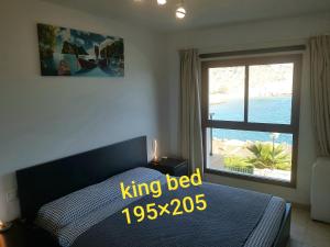 a bedroom with a king bed and a large window at DELUXE 3 Rooms74m2,TRANSFE-R inc! SEAVIEW on AMADORES,2 heatPOOLs, PARKING, 600 MB,Dishwasher,2Lift,,3 BEACHes in Playa del Cura