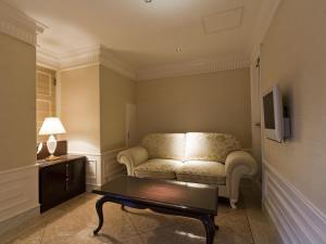 a living room with a couch and a coffee table at Hotel Fine Aroma Dotonbori in Osaka