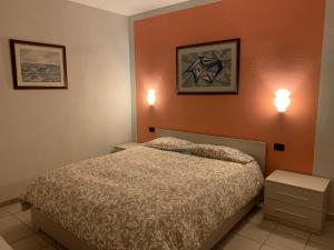 Säng eller sängar i ett rum på Appartamento Lidia