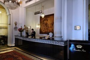a man standing at a counter in a lobby at Windsor Palace Luxury Heritage Hotel Since 1906 by Paradise Inn Group in Alexandria