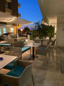 a restaurant with tables and chairs at night at Hotel Majestic in Gabicce Mare