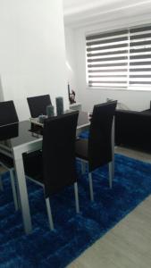 a living room with a table and chairs and a couch at Casa da Boa Agua 1 in Quinta do Conde