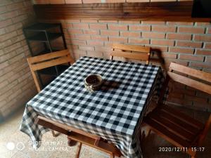 a black and white checkered table and two chairs at Cabaña AAA in Xuí