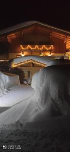 a bed covered in snow in a room at Chalet Heidi in Kartitsch