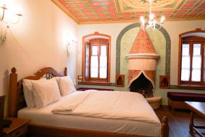 a bedroom with a bed with a fireplace at Argjiro Traditional in Gjirokastër