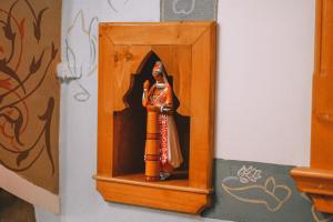 a small wooden figurine in a wooden box at Argjiro Traditional in Gjirokastër