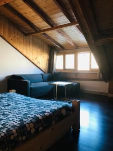 a room with a bed and a couch and a table at Appartement de montagne Briançon in Briançon