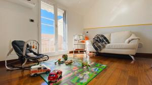 a living room with a couch and toy cars on a rug at Babyaccommodation Family Exclusive in Borgio Verezzi