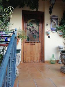 a wooden door with a window on a house at La Casa de la Abuela María in Baeza