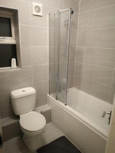 a white bathroom with a toilet and a shower at Wherstead Road House in Ipswich