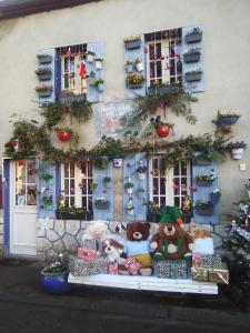 a display of stuffed animals in front of a building at La Roulotte De Lola - Chambre d'hôtes in La Celle