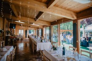 a dining room with white tables and chairs at Hotel La Val in Valdidentro