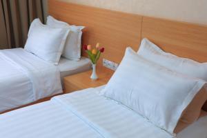 מיטה או מיטות בחדר ב-City INN Hotel