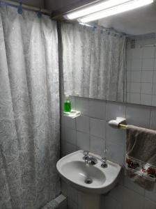 a bathroom with a sink and a shower curtain at Francais in La Paloma