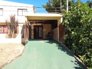 a house with a green driveway in front of a house at Francais in La Paloma