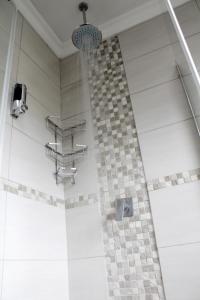 a bathroom with a shower with a checkered floor at Midrand Bed and Breakfast in Midrand