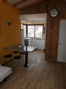 a kitchen with a table and chairs in a room at Casas Rocamar in Totoralillo