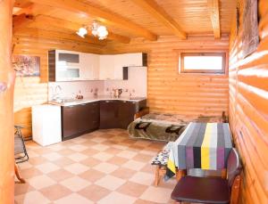 a room with a kitchen and a table in it at Cottage Gutsulia in Yaremche