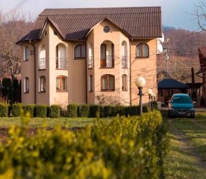 a house with a car parked in front of it at Cottage Gutsulia in Yaremche
