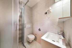 Un baño blanco con inodoro y lavabo. en Apartments Liljana Privlaka, en Privlaka 79 fotos más